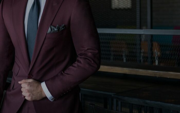 homme costume bordeaux assis